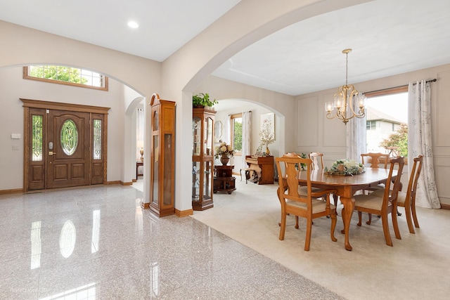 2024 Taller Rd, Morris, IL 60450 - dining area featuring arched walkways, granite floors, a chandelier, recessed lighting, and a decorative wall