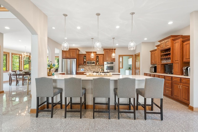 2024 Taller Rd, Morris, IL 60450 - kitchen featuring stainless steel appliances, light countertops, brown cabinetry, tasteful backsplash, and recessed lighting