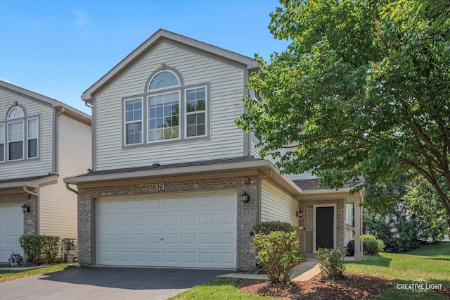 1836 Candlelight Cir Unit 1836, Montgomery, IL 60538 - view of front of house with driveway, a garage, and brick siding