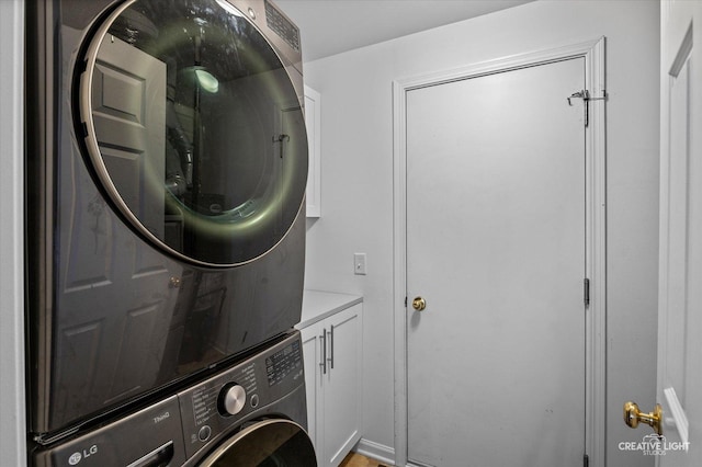 1836 Candlelight Cir Unit 1836, Montgomery, IL 60538 - washroom with stacked washer / dryer and cabinet space