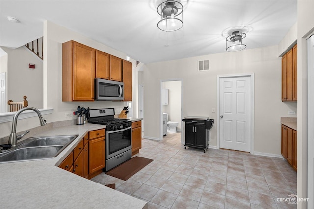 1836 Candlelight Cir Unit 1836, Montgomery, IL 60538 - kitchen featuring appliances with stainless steel finishes, brown cabinets, light countertops, and light tile patterned floors