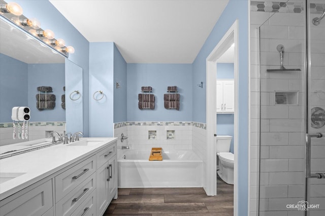 1836 Candlelight Cir Unit 1836, Montgomery, IL 60538 - full bathroom featuring a garden tub, double vanity, wood finished floors, a shower stall, and tile walls