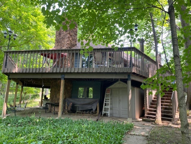 23 Acapulco Dr, Putnam, IL 61560 - rear view of property featuring stairs, a wooden deck, and a chimney