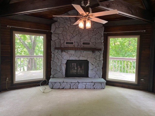 23 Acapulco Dr, Putnam, IL 61560 - unfurnished living room with carpet flooring, a fireplace, ceiling fan, and wooden walls
