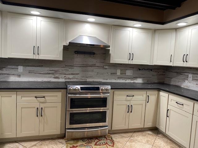 23 Acapulco Dr, Putnam, IL 61560 - kitchen with light tile patterned flooring, range with two ovens, tasteful backsplash, dark countertops, and ventilation hood