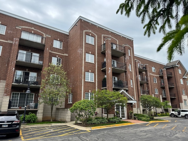 1479 N Milwaukee Ave Unit 312, Libertyville, IL 60048 - view of apartment building / complex featuring uncovered parking