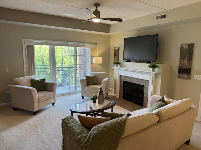 1479 N Milwaukee Ave Unit 312, Libertyville, IL 60048 - living room with carpet, a ceiling fan, healthy amount of natural light, and a tiled fireplace