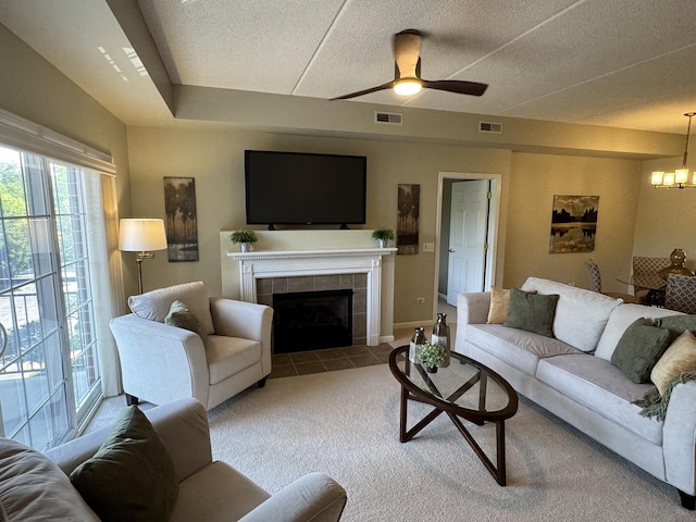 1479 N Milwaukee Ave Unit 312, Libertyville, IL 60048 - tiled living room with a chandelier, carpet, ceiling fan, a fireplace, and a textured ceiling
