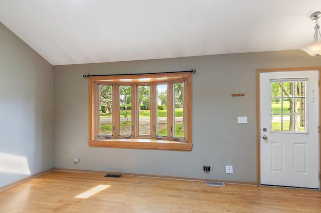 3 Clark Ave, Lake In The Hills, IL 60156 - foyer entrance with healthy amount of natural light, wood finished floors, and vaulted ceiling