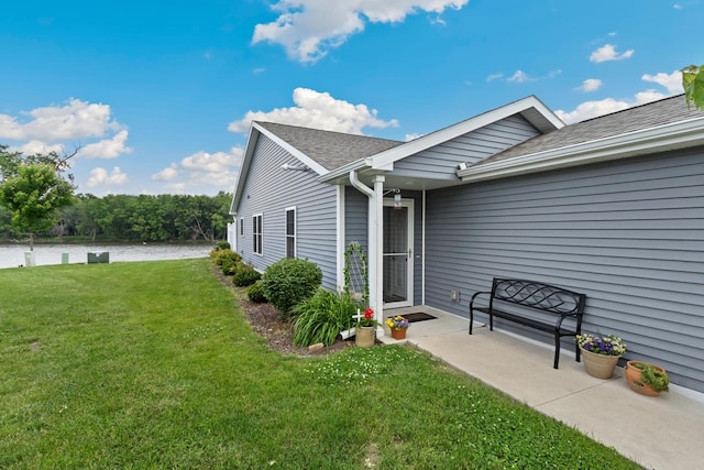 1523 Eadens Pl Unit 1523, Dixon, IL 61021 - doorway to property featuring a yard, a shingled roof, and a water view