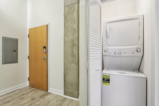 1000 W Adams St Unit 523, Chicago, IL 60607 - washroom featuring stacked washing machine and dryer, electric panel, and light wood-style flooring