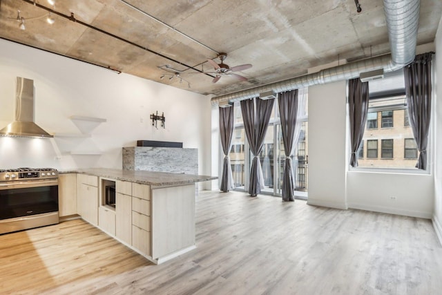 1000 W Adams St Unit 523, Chicago, IL 60607 - kitchen featuring gas stove, wall chimney exhaust hood, light wood finished floors, and light brown cabinetry