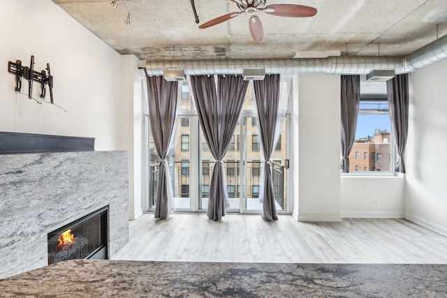 1000 W Adams St Unit 523, Chicago, IL 60607 - unfurnished living room featuring wood finished floors, a lit fireplace, and a ceiling fan