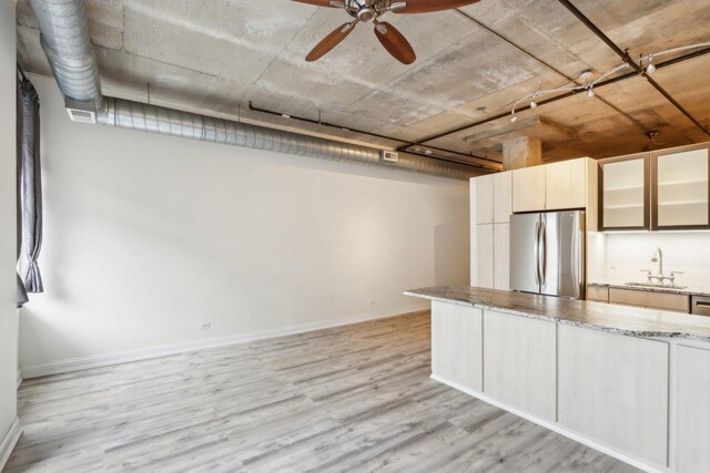 1000 W Adams St Unit 523, Chicago, IL 60607 - kitchen with freestanding refrigerator, light wood finished floors, light stone countertops, glass insert cabinets, and ceiling fan