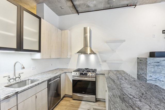 1000 W Adams St Unit 523, Chicago, IL 60607 - kitchen featuring appliances with stainless steel finishes, wall chimney exhaust hood, light wood finished floors, light stone countertops, and light brown cabinets