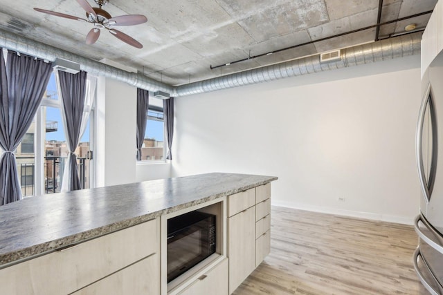 1000 W Adams St Unit 523, Chicago, IL 60607 - kitchen with black microwave, freestanding refrigerator, light wood finished floors, a ceiling fan, and modern cabinets
