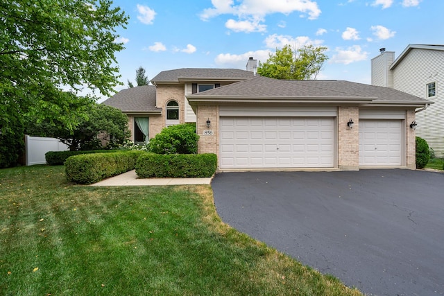 856 Fieldcrest Dr, Bolingbrook, IL 60490 - traditional-style home featuring brick siding, driveway, a front lawn, an attached garage, and a shingled roof