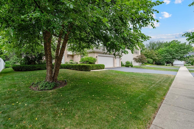 856 Fieldcrest Dr, Bolingbrook, IL 60490 - obstructed view of property with asphalt driveway, a front yard, a garage, and brick siding