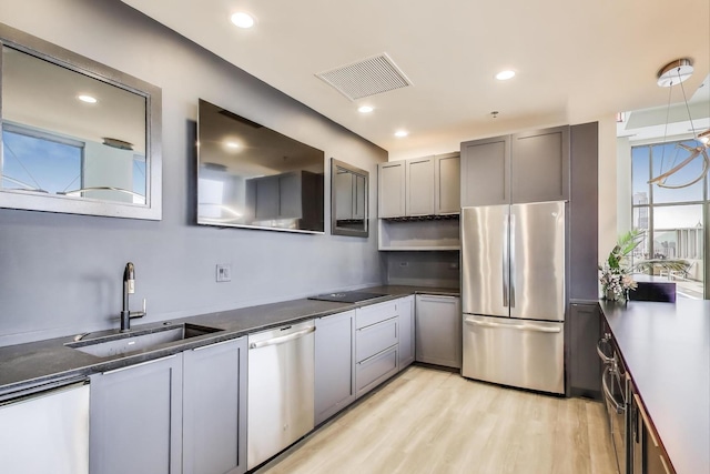 1841 S Calumet Ave Unit 1808, Chicago, IL 60616 - kitchen with appliances with stainless steel finishes, dark countertops, light wood-style flooring, gray cabinetry, and recessed lighting