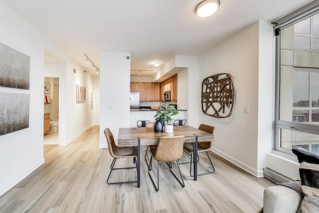 1841 S Calumet Ave Unit 1808, Chicago, IL 60616 - dining area with light wood-type flooring, track lighting, and a baseboard heating unit