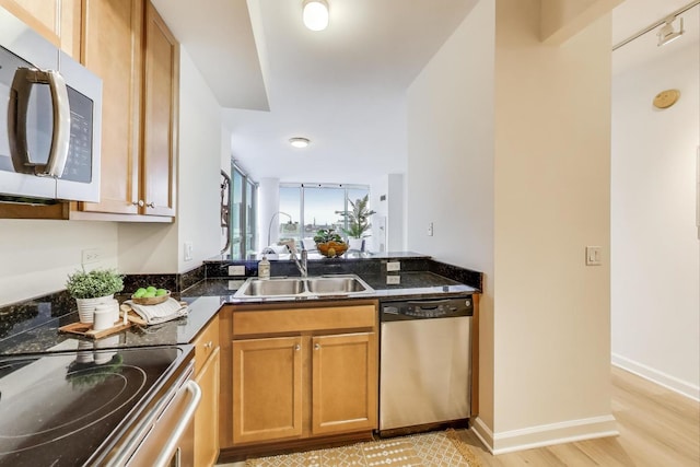 1841 S Calumet Ave Unit 1808, Chicago, IL 60616 - kitchen featuring stainless steel appliances, brown cabinets, dark stone counters, and light wood finished floors