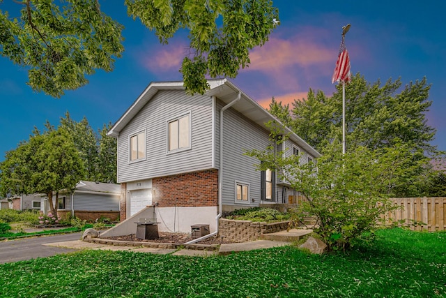 570 Sundance Ct, Carol Stream, IL 60188 - property exterior at dusk featuring a garage and brick siding