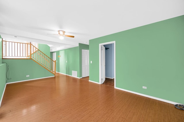570 Sundance Ct, Carol Stream, IL 60188 - unfurnished room featuring stairway, wood finished floors, and a ceiling fan