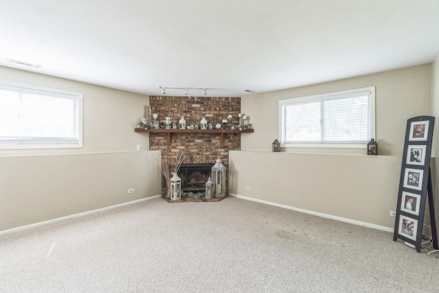 1316 Fireside Ct, Naperville, IL 60564 - unfurnished living room featuring track lighting, carpet, and a brick fireplace