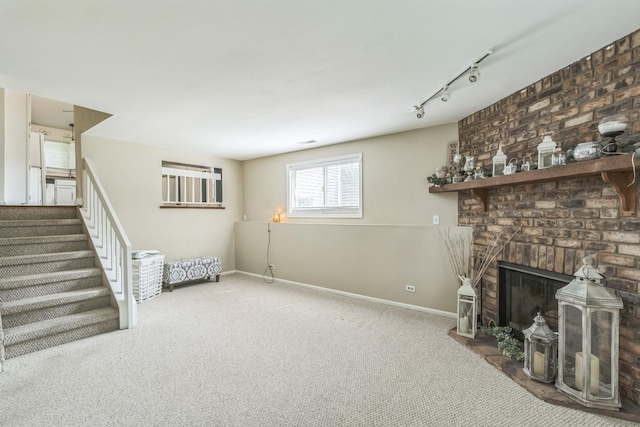 1316 Fireside Ct, Naperville, IL 60564 - unfurnished living room with carpet floors, rail lighting, stairway, and a brick fireplace