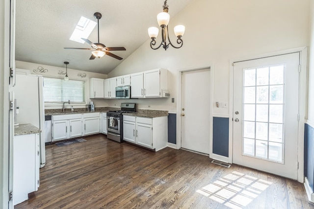 1316 Fireside Ct, Naperville, IL 60564 - kitchen featuring appliances with stainless steel finishes, white cabinets, a skylight, a ceiling fan, and decorative light fixtures