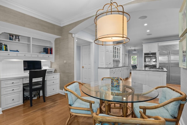 545 Sheridan Rd, Winnetka, IL 60093 - dining area featuring light wood-style flooring, crown molding, built in study area, and recessed lighting