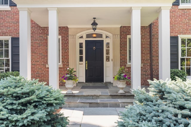 545 Sheridan Rd, Winnetka, IL 60093 - doorway to property featuring brick siding and a porch