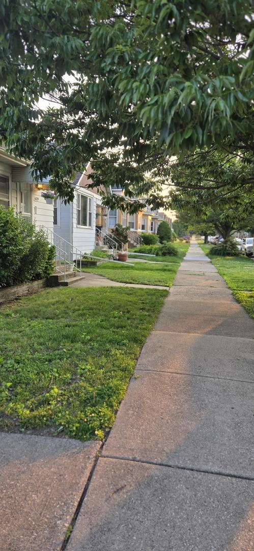 6119 W School St, Chicago, IL 60634 - view of front of house with a front lawn