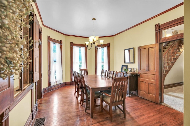 201 W Yates, Newman, IL 61942 - dining space featuring a chandelier, dark wood-type flooring, crown molding, and stairway