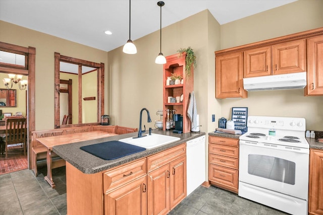 201 W Yates, Newman, IL 61942 - kitchen featuring white appliances, under cabinet range hood, a peninsula, dark countertops, and hanging light fixtures