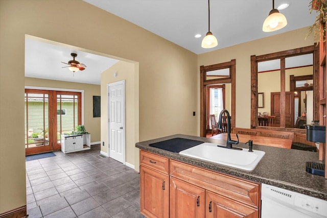 201 W Yates, Newman, IL 61942 - kitchen with white dishwasher, dark countertops, plenty of natural light, dark tile patterned floors, and recessed lighting