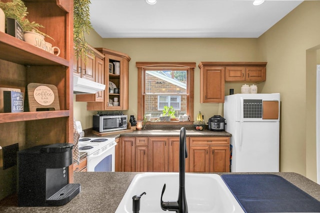 201 W Yates, Newman, IL 61942 - kitchen featuring white appliances, under cabinet range hood, dark countertops, brown cabinetry, and recessed lighting