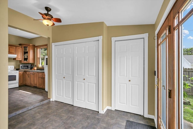 201 W Yates, Newman, IL 61942 - kitchen with white range with electric stovetop, under cabinet range hood, healthy amount of natural light, and a ceiling fan