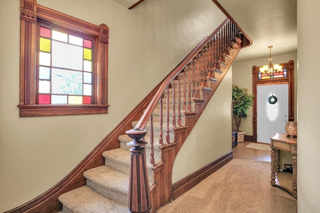 201 W Yates, Newman, IL 61942 - stairway with a chandelier, tile patterned flooring, and carpet flooring