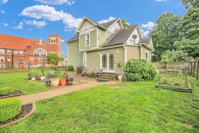 201 W Yates, Newman, IL 61942 - rear view of property with a vegetable garden, a patio area, and a shingled roof