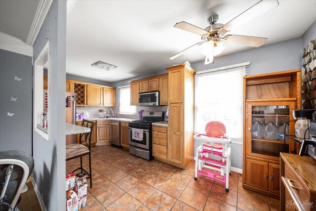 413 Glen Ave, Romeoville, IL 60446 - kitchen featuring appliances with stainless steel finishes, light countertops, a ceiling fan, and backsplash