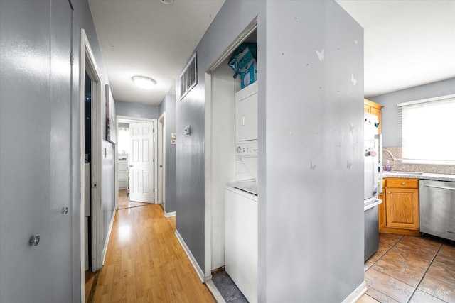 413 Glen Ave, Romeoville, IL 60446 - hallway featuring stacked washer / drying machine and a sink