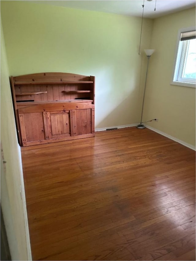 301 N Stevenson Ln, Mount Prospect, IL 60056 - unfurnished living room featuring wood finished floors and baseboards