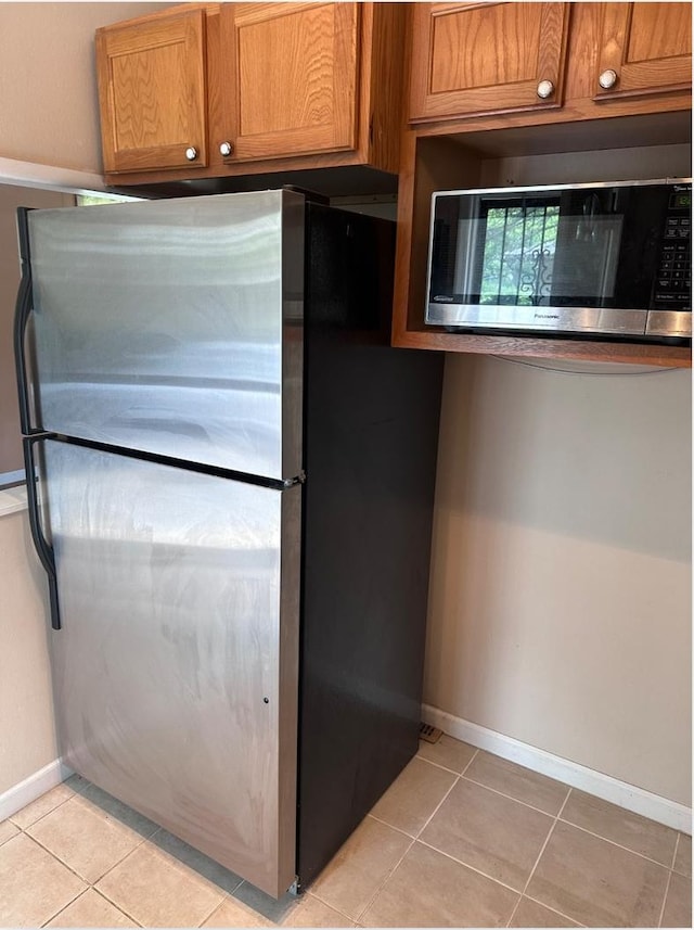 301 N Stevenson Ln, Mount Prospect, IL 60056 - kitchen with stainless steel appliances, brown cabinetry, and light tile patterned flooring