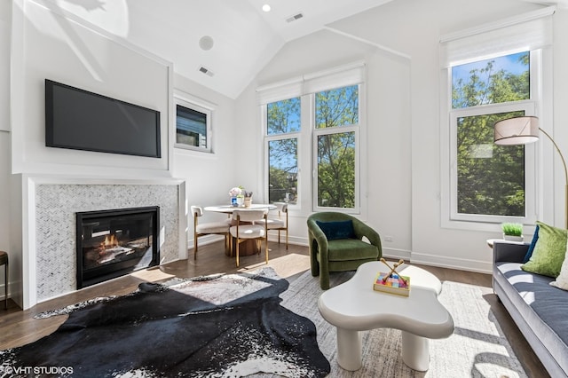 2138 N Sawyer Ave Unit 2, Chicago, IL 60647 - living area with wood finished floors, lofted ceiling, a glass covered fireplace, and recessed lighting