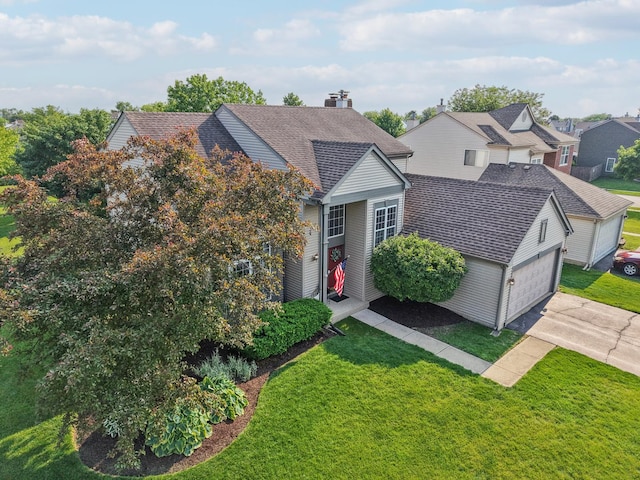 1995 Ridgemore Dr, Bartlett, IL 60103 - traditional home with a garage, driveway, a front lawn, and a shingled roof