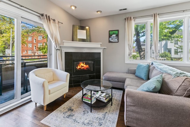 2656 N Hamlin Ave Unit 1W, Chicago, IL 60647 - living room with plenty of natural light, a tiled fireplace, dark wood finished floors, and recessed lighting