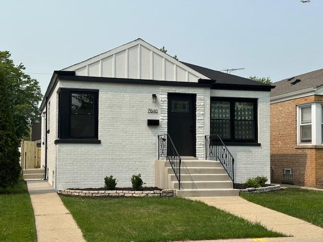 7646 W Myrtle Ave, Chicago, IL 60631 - bungalow-style house featuring brick siding, a front lawn, and board and batten siding