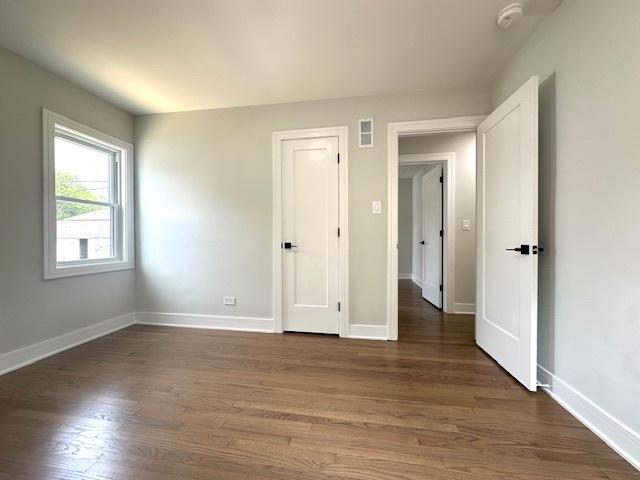 7646 W Myrtle Ave, Chicago, IL 60631 - unfurnished bedroom featuring wood finished floors