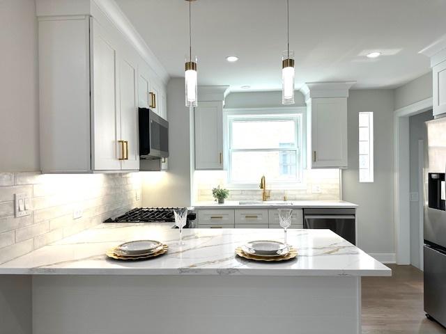 7646 W Myrtle Ave, Chicago, IL 60631 - kitchen with dishwashing machine, stainless steel fridge, backsplash, a peninsula, and light stone countertops